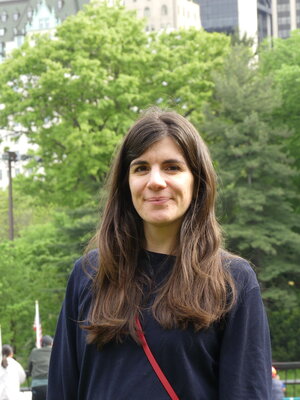 A brunette woman smiling. 